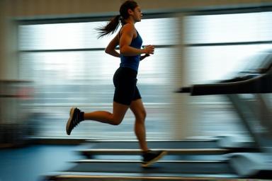 Person running with energy on a treadmill during cardio workout
